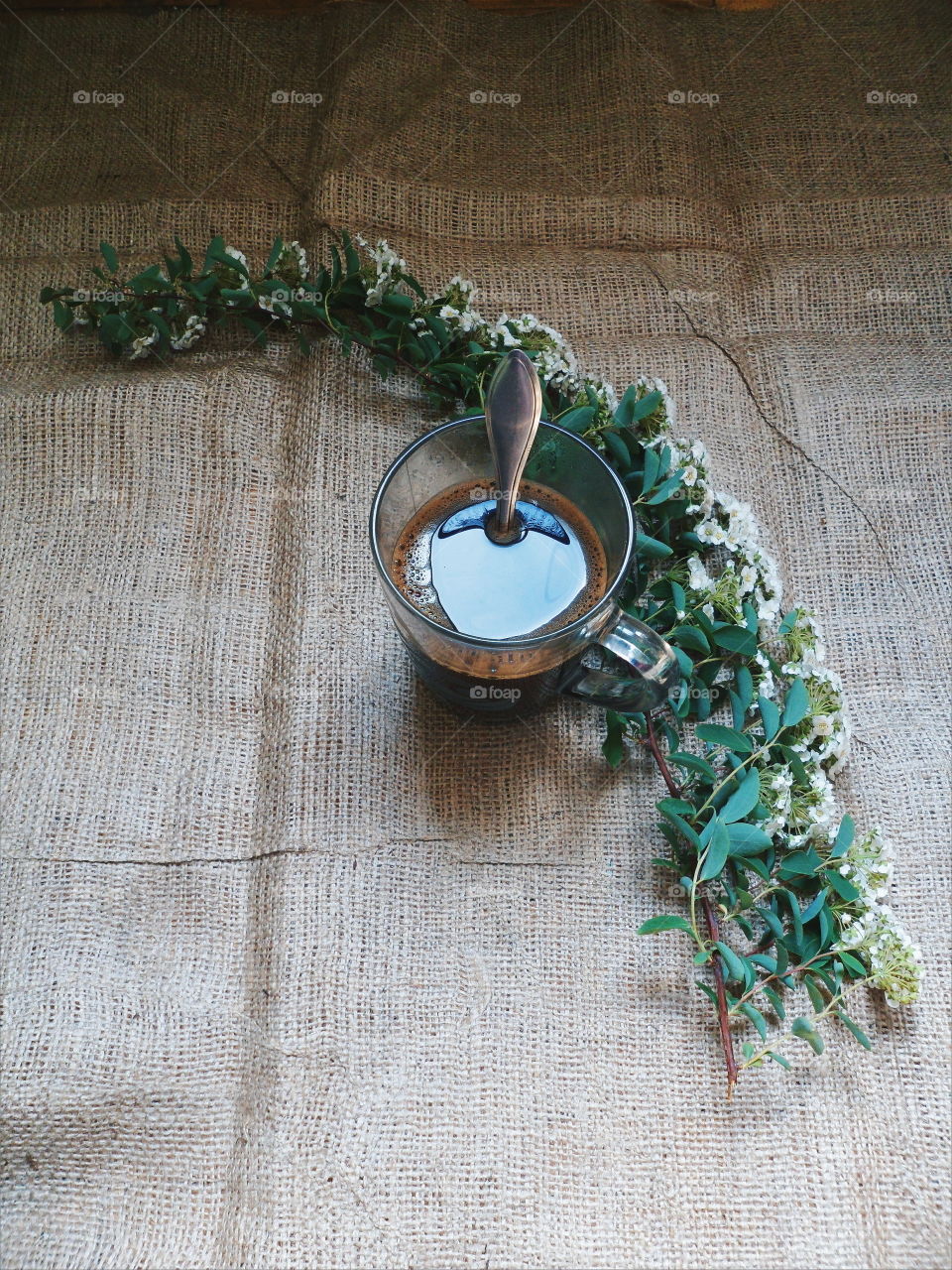 A cup of coffee and a bouquet of flowers