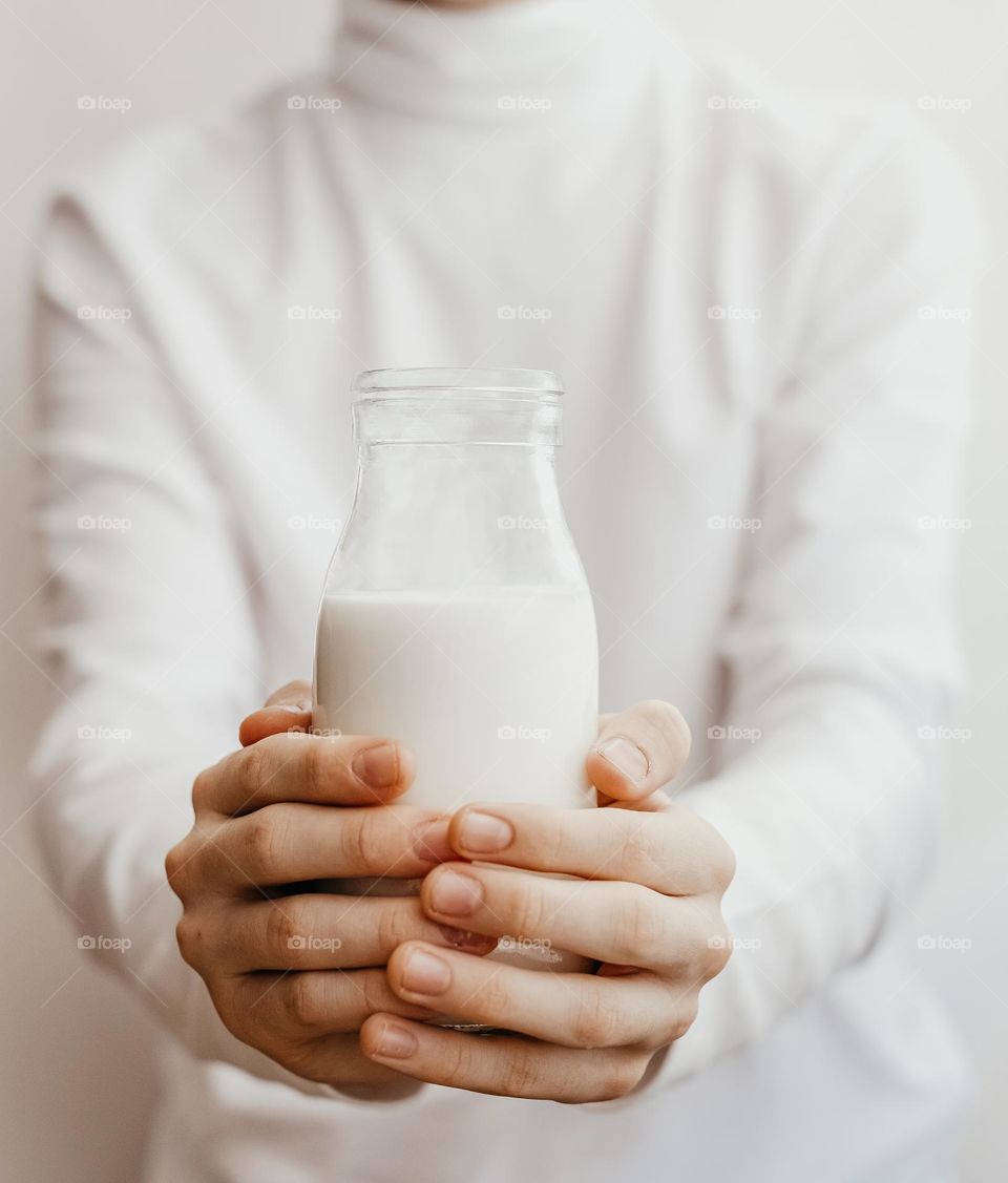 person holding a bottle of milk