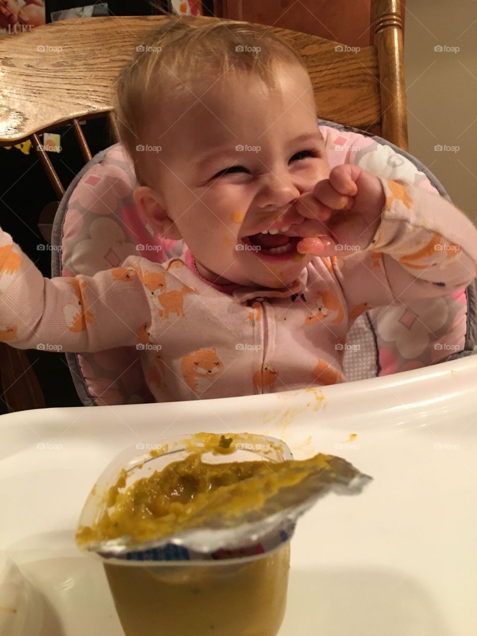 Happy toddler boy sitting with his food