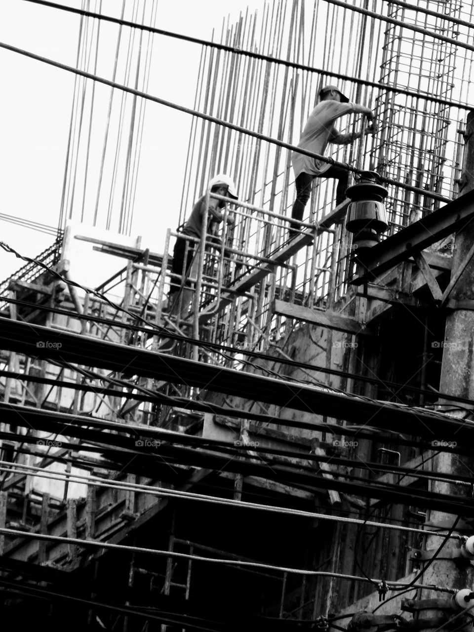 Behind the power lines there is a building project