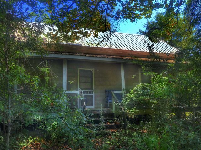 Abandoned behind a gate and in the woods 