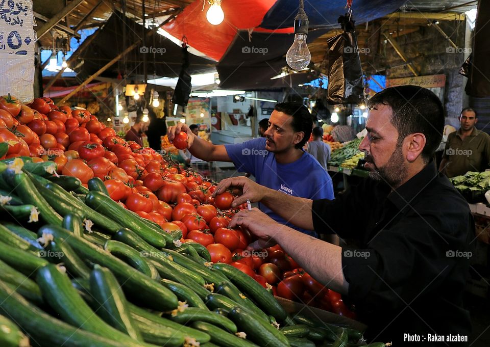 Worker arrange vegetables in the city center