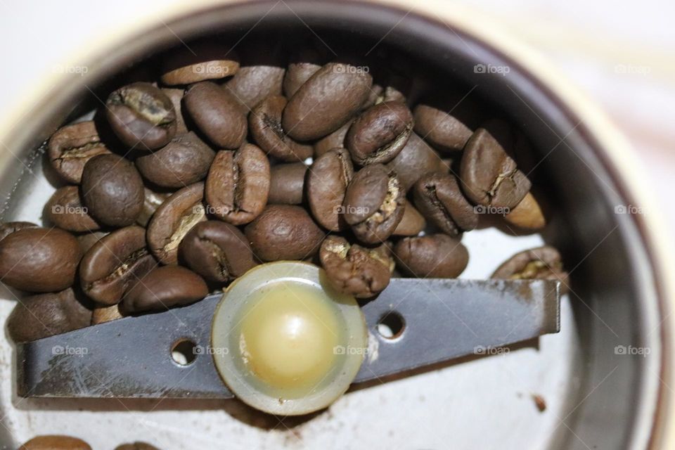 coffee beans in a coffee grinder