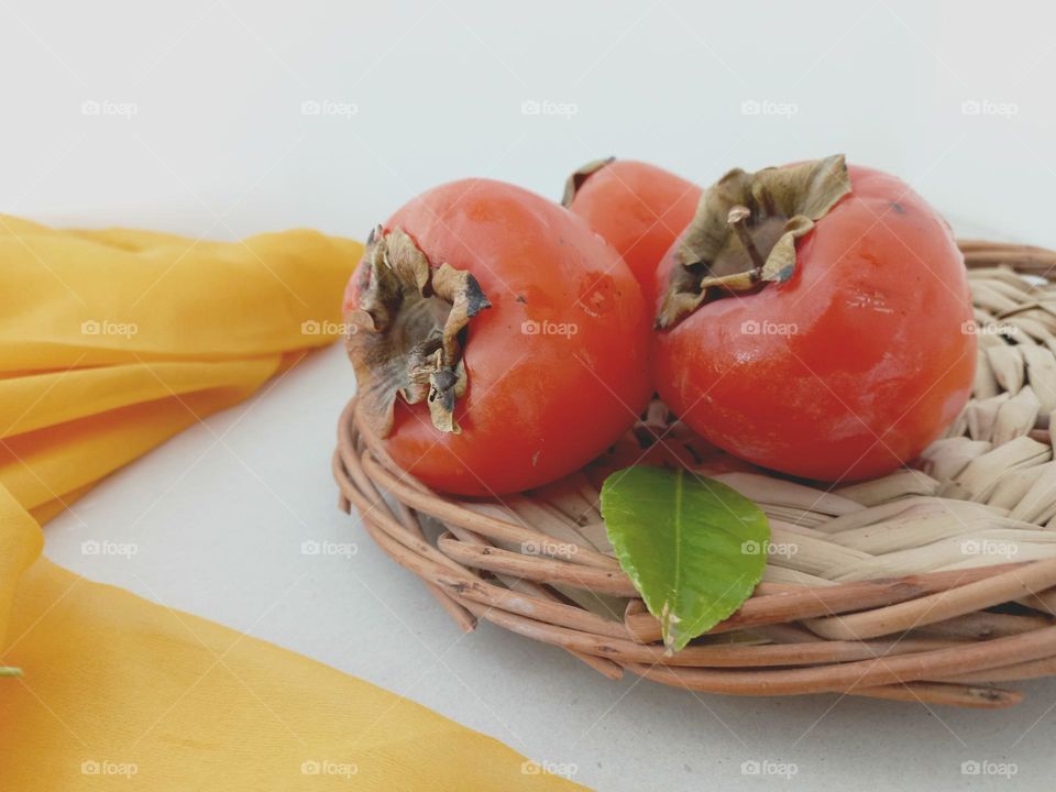 orange persimmon in a basket