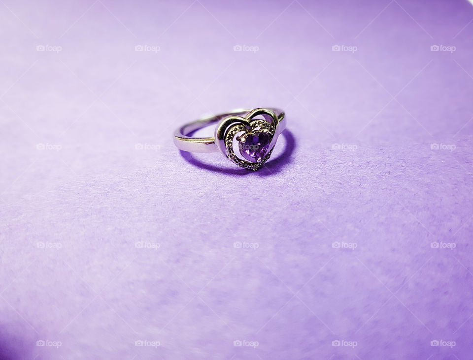 Wedding ring against purple background