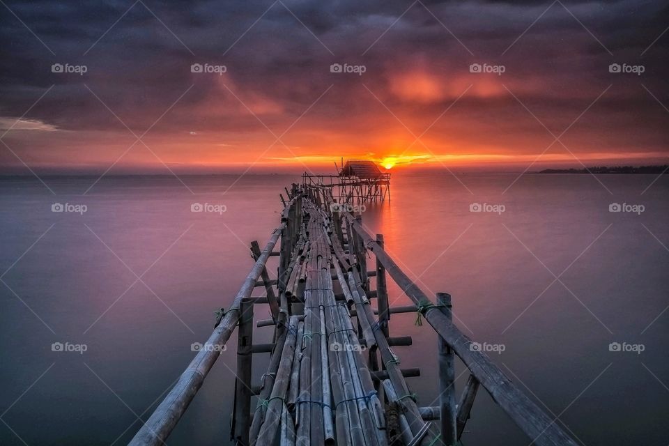 Bamboo pier bridge at beautiful sunset
