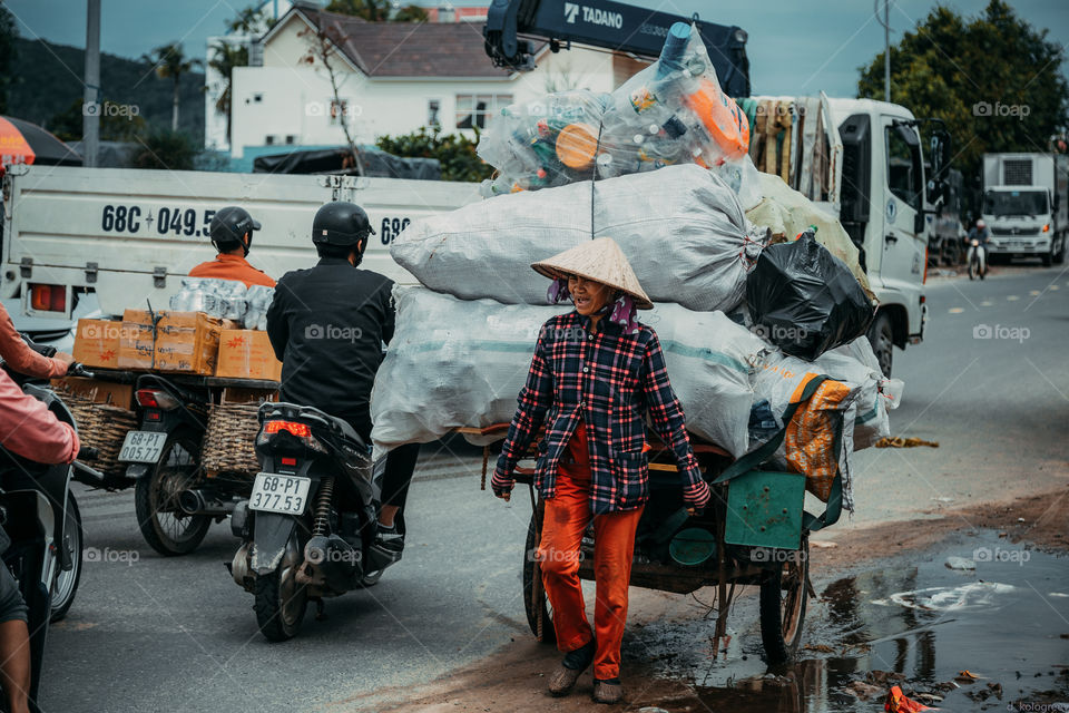 Vietnamese woman drags a huge cart