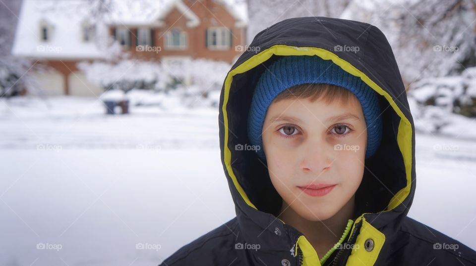 Portrait of a boy in the winter on a snowy street