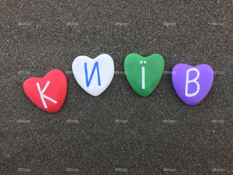 Київ,Україна, souvenir of Kiev with four colored heart stones over black volcanic sand
