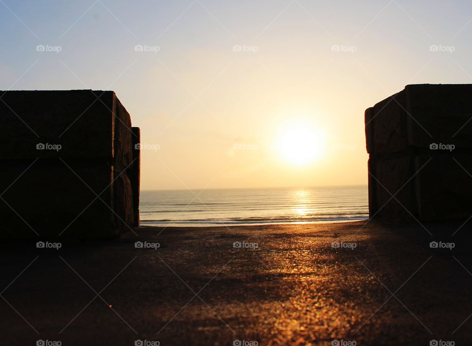 u sunset in beach framed between rocks