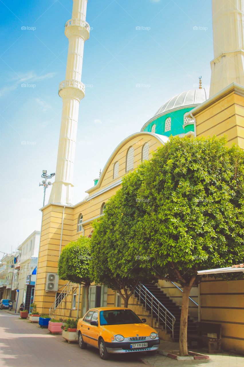 Turkey view. Yellow mosque and yellow car in Turkey