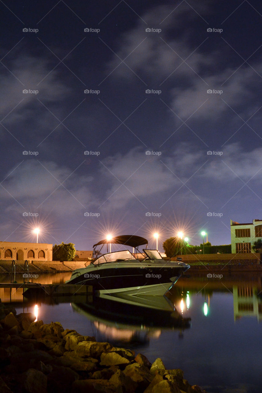 boat and its reglection in the river at night