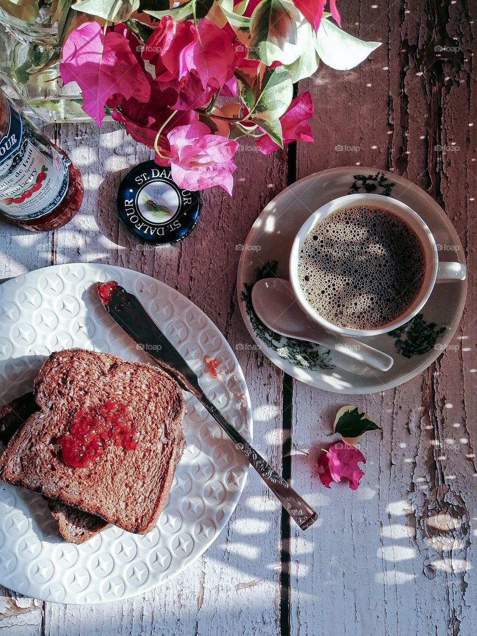 Slice bread, toast bread with strawberry jam served with black coffee for breakfast.