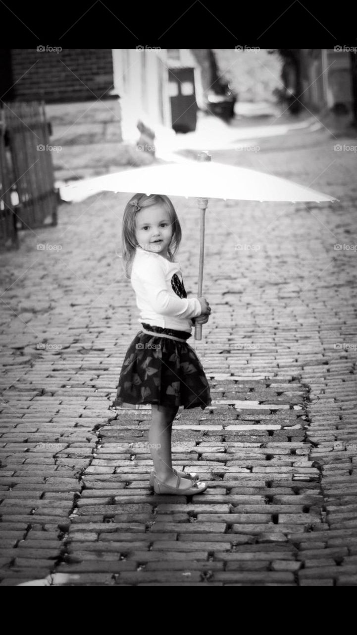 Little girl with umbrella in black and white