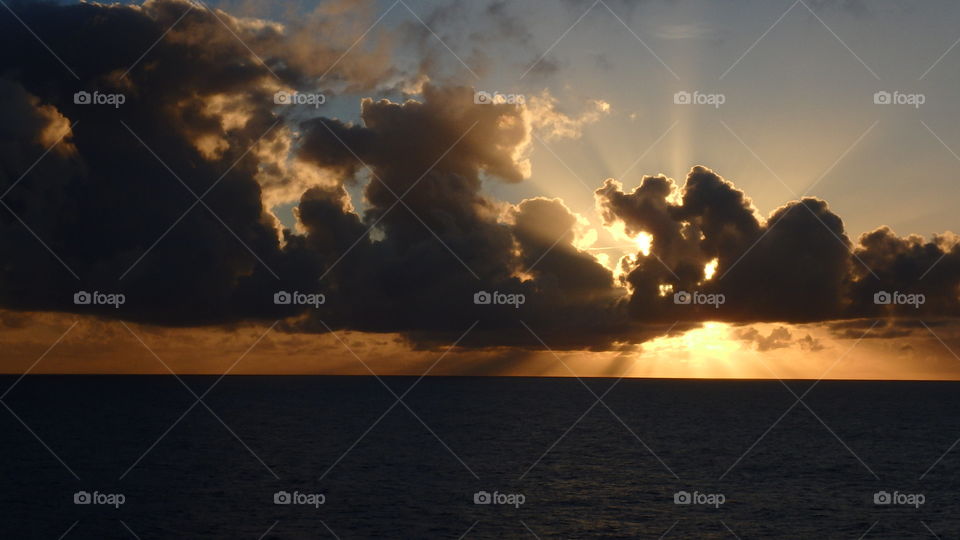 Calm sea with massive of cloud formations add with the sun rays of light...  amazing