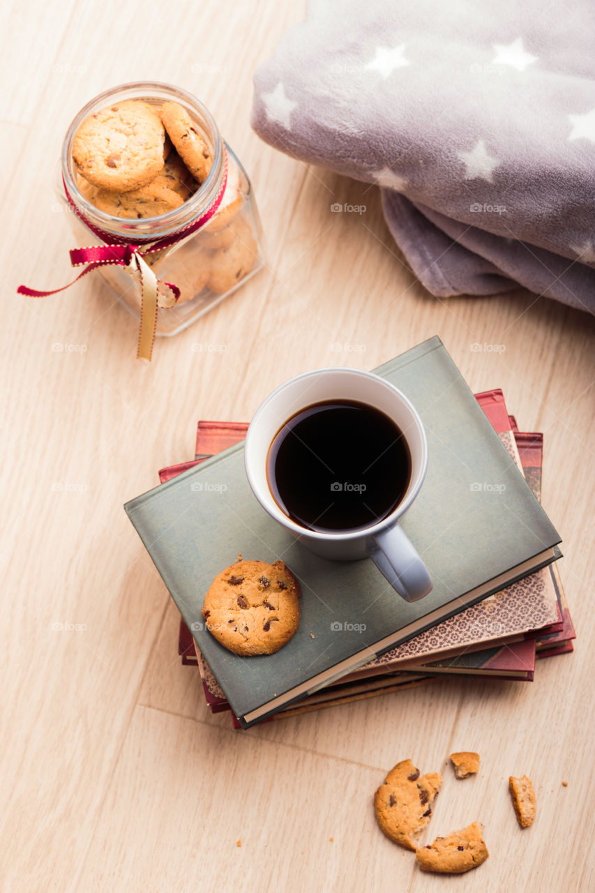 A few books with cup of coffee and cookies on wooden floor. Time for relax. Spending leisure time on reading. Cozy and comfortable. Relaxing 😌