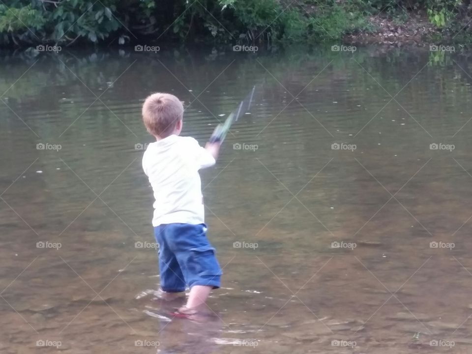 Boy casting fishing line