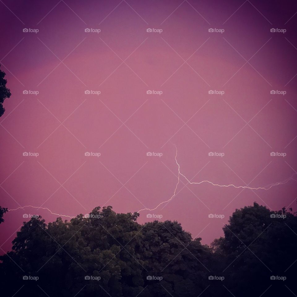 Lightning under a rainbow at dusk.

Central Massachusetts June 2017