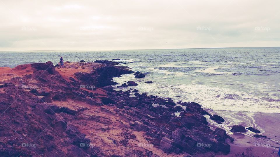 Lovers rocks sea. Couple on a rugged sea coast