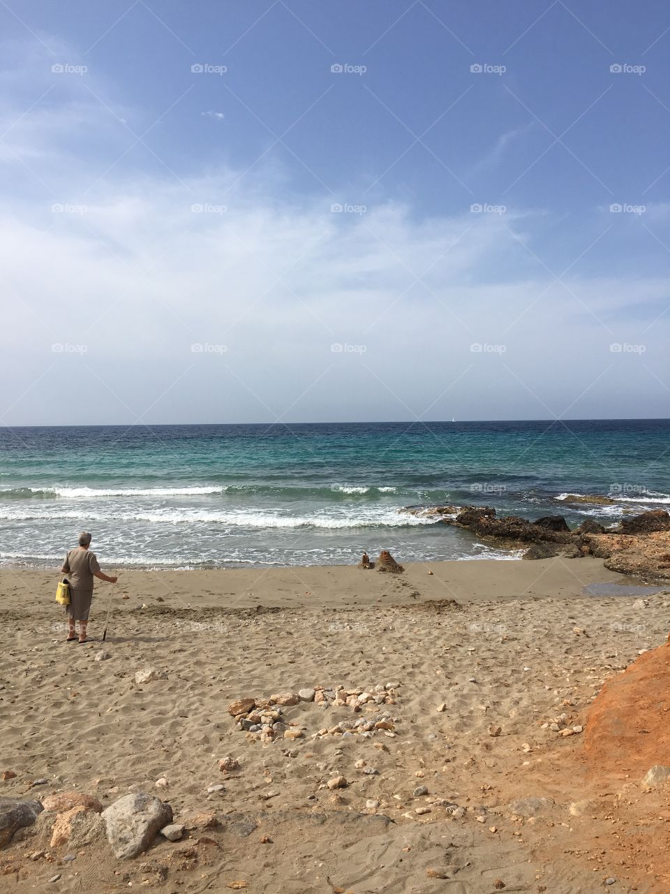 Enjoining the beach day. Old lady looking forward 