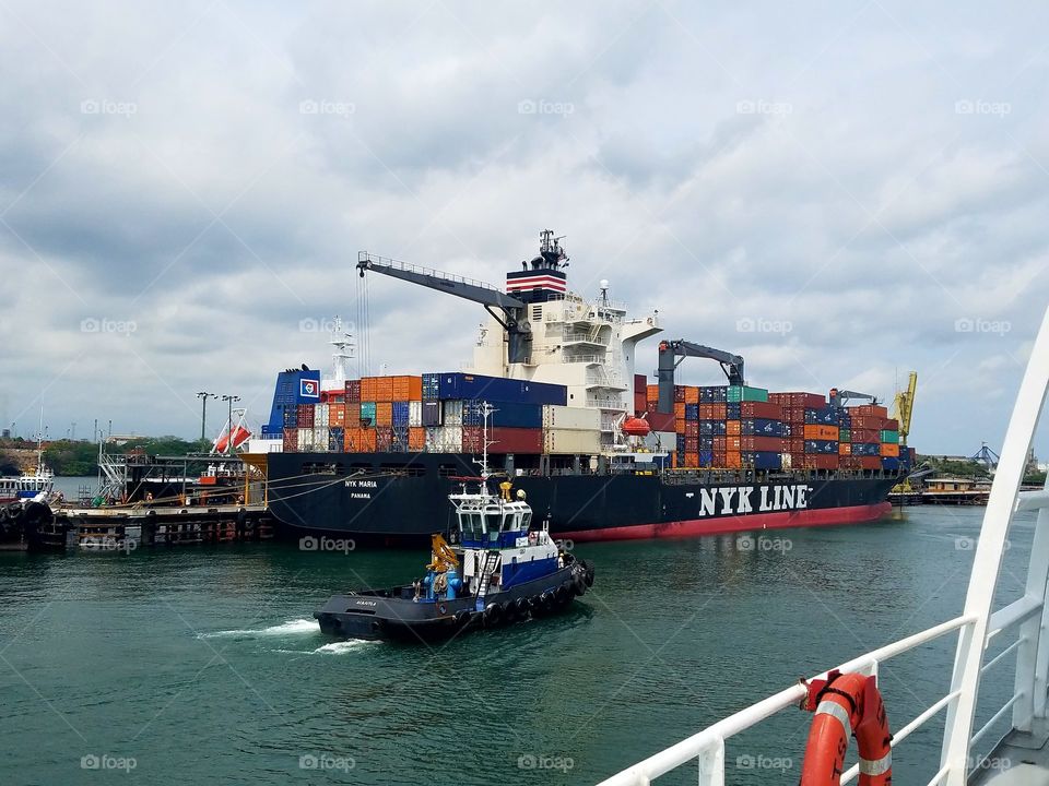 Tug Acajutla and NYK Lines Maria in the port of Acajutla, El Salvador.