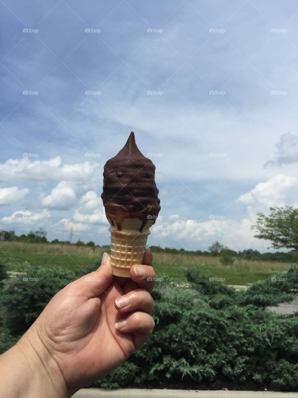 Chocolate Dipped Cone. Enjoying a chocolate dipped ice cream cone on a hot summer day.  Yummy! 