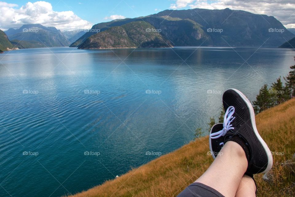 Low section of person at lakeshore, Eidfjord