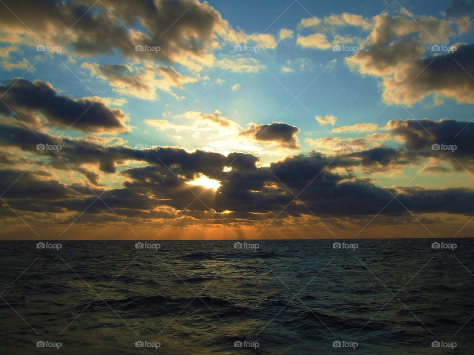 sunset at the ocean from a ship at sea