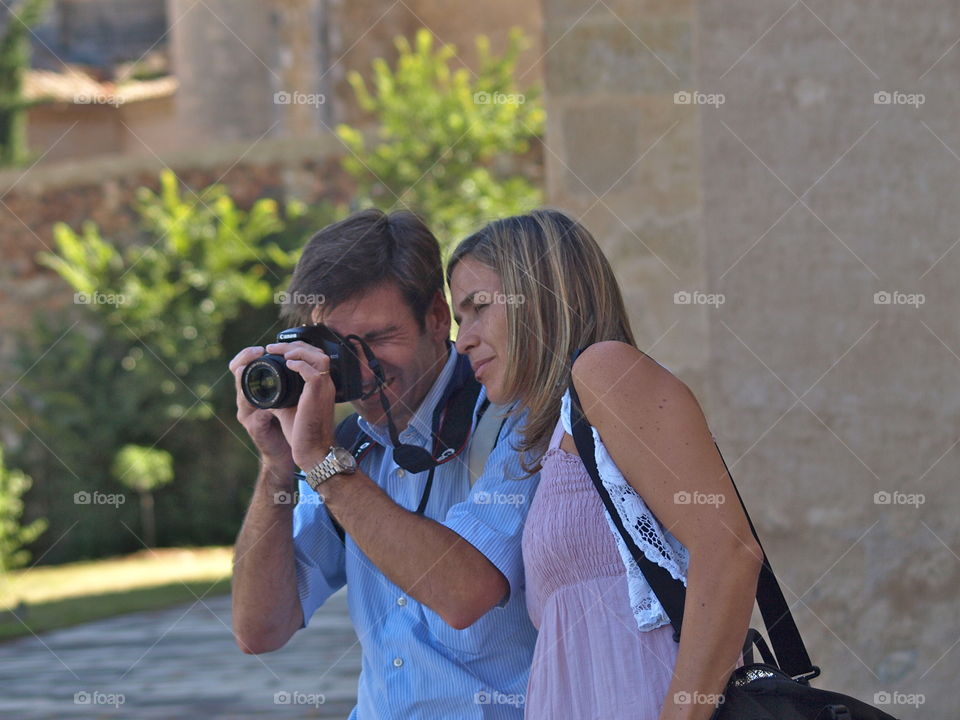 Man photographing with woman