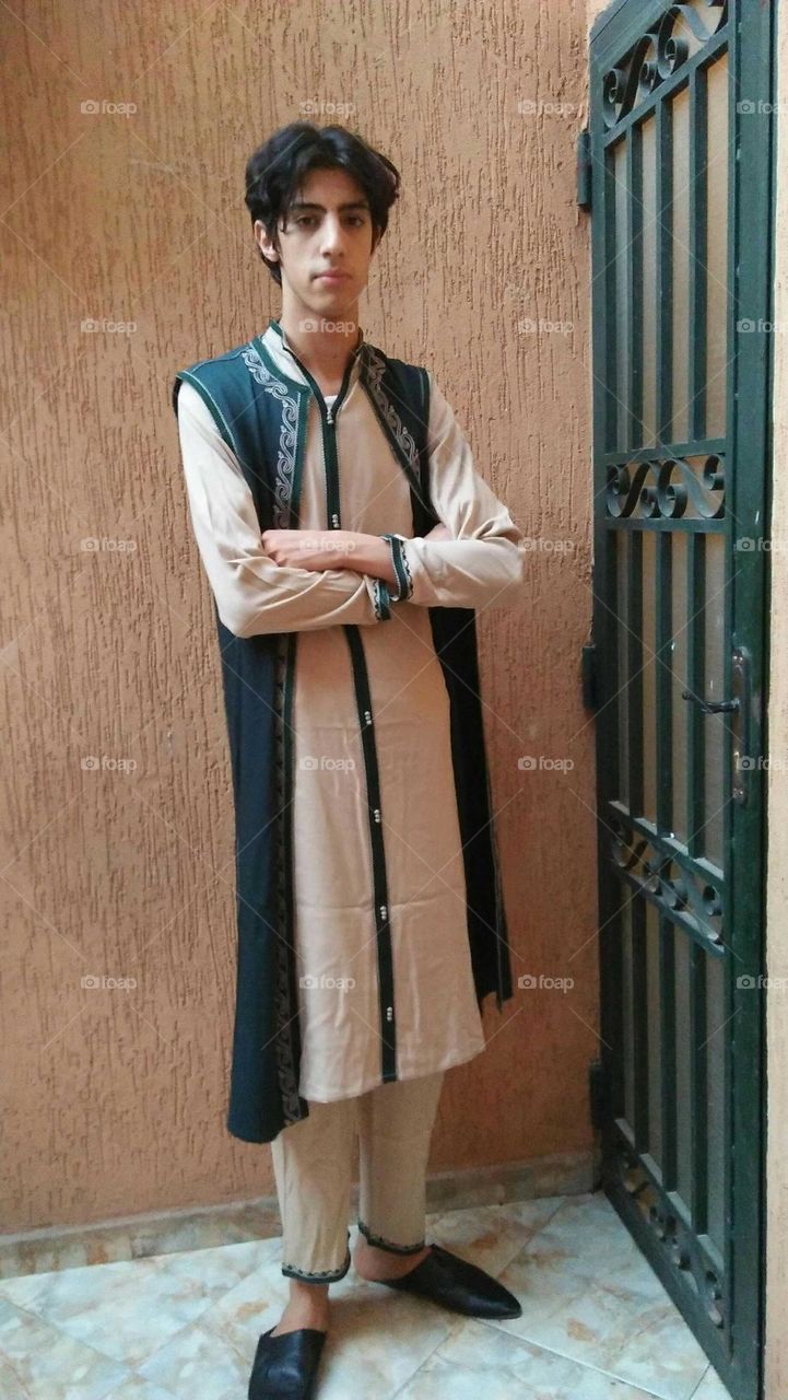 A handsome and young man wearing traditional clothes