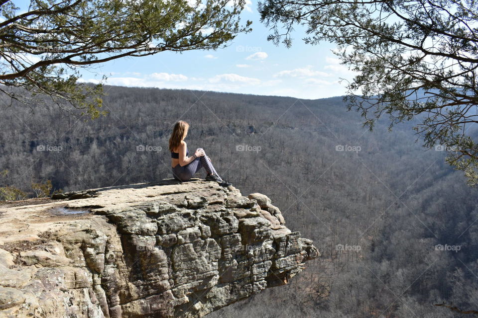 Girl sitting on rock 