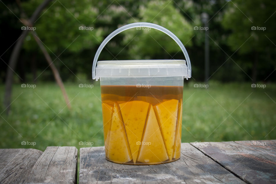 Cheese in olive oil on a cube