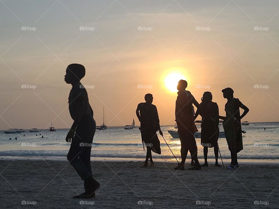 Silhouettes of people on the beach in Zanzibar