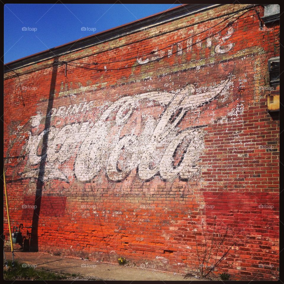 Old coke sign on brick