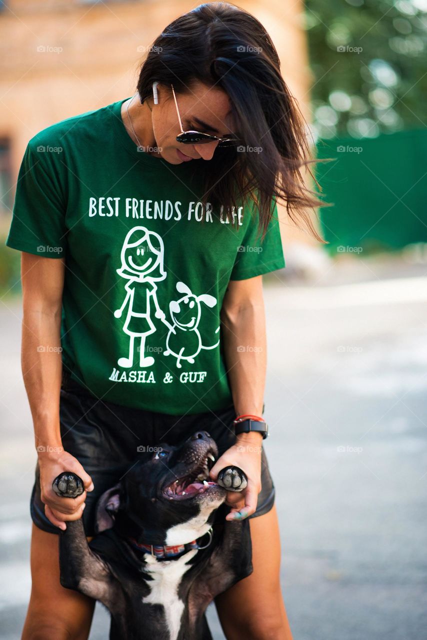 cool friends, a girl and her dog, walking on the street