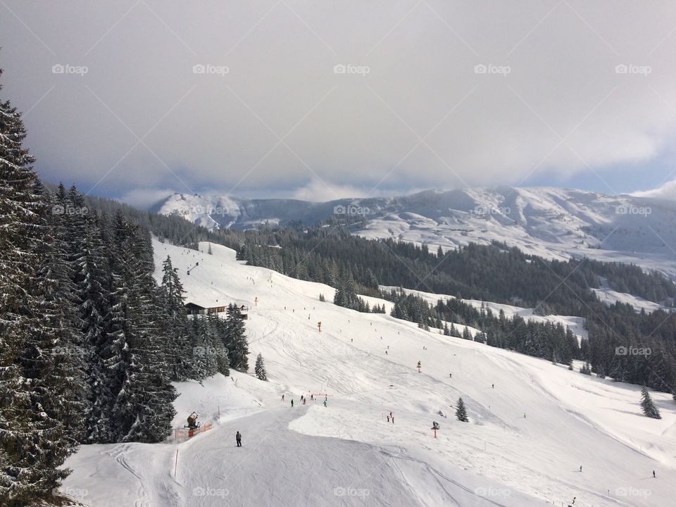 Top of a mountain ski run with piste leading into the valley, Kirchberg, Kitzbuhel, Tirol Austria