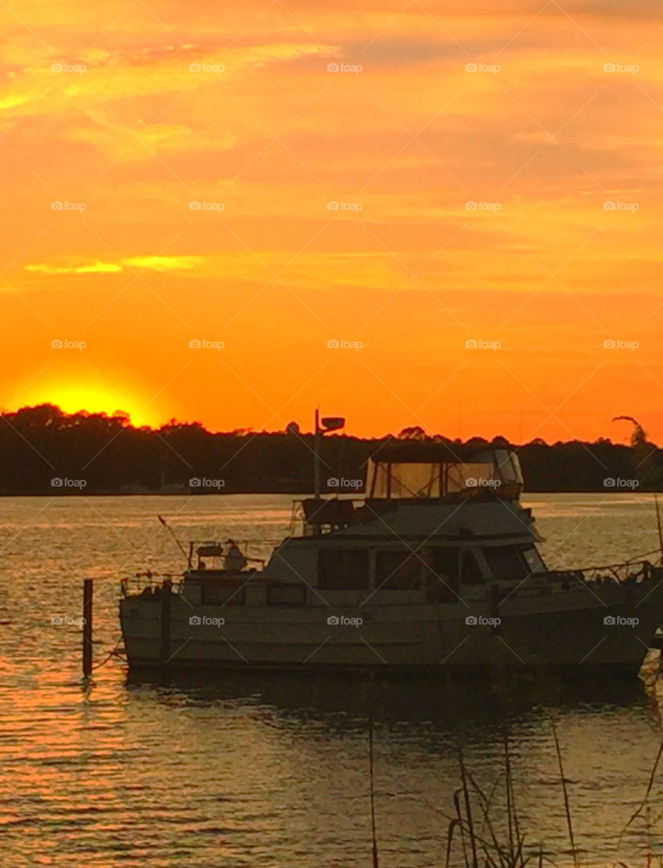 Ship in sea at sunset