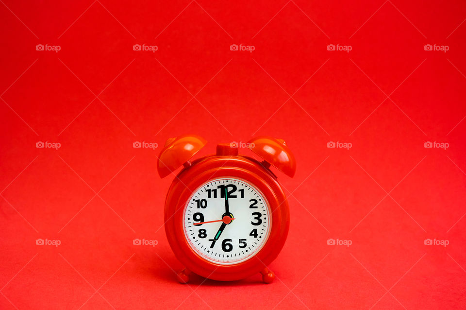 Clock isolated on red background with copy space 