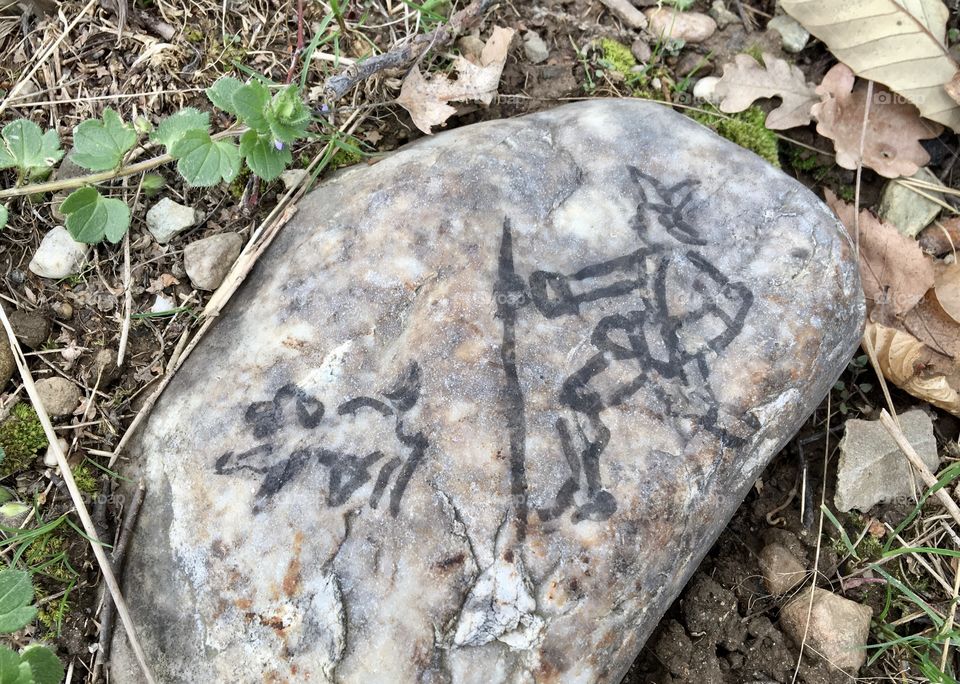 ... with Black drawing on a stone : a man with hat hiking with a dog - #1
