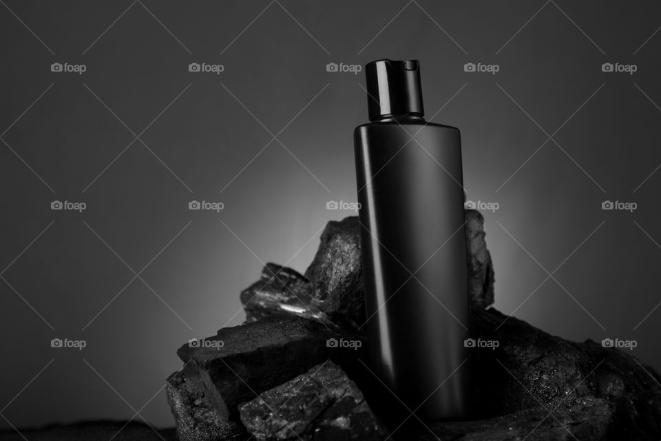 Black colored product with charcoal for mockup