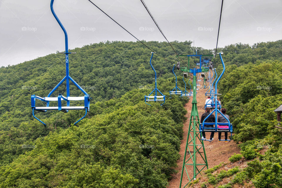 Couple rides ski lift at hill