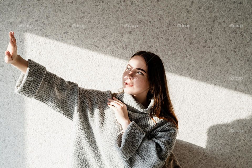 creative woman portrait indoors with light and shadow play