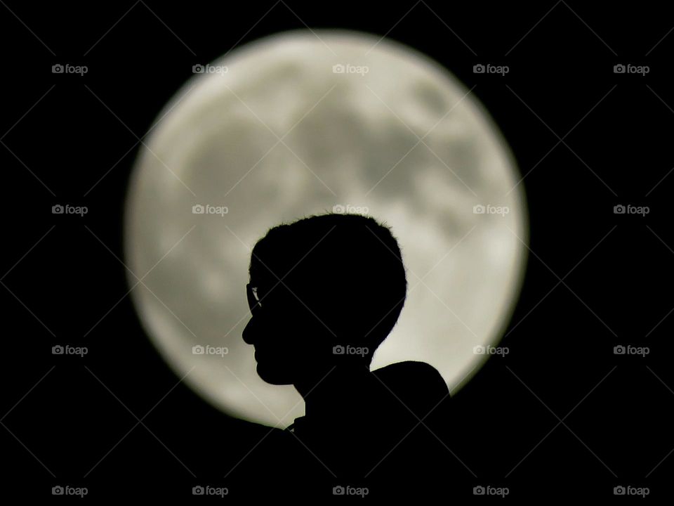 My brother with the moon behind him