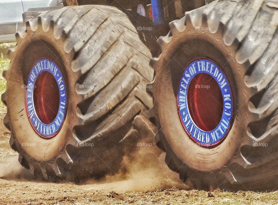 Monster Truck Wheels. Wheels Of An American Monster Truck Tearing Through The Dirt
