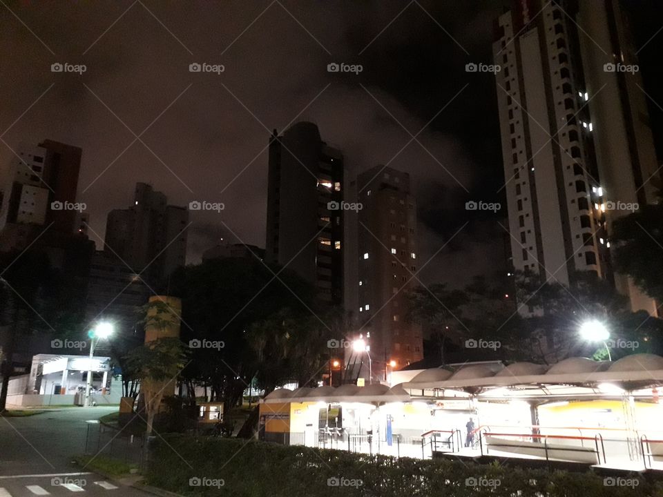 Bus terminal and buildings at night