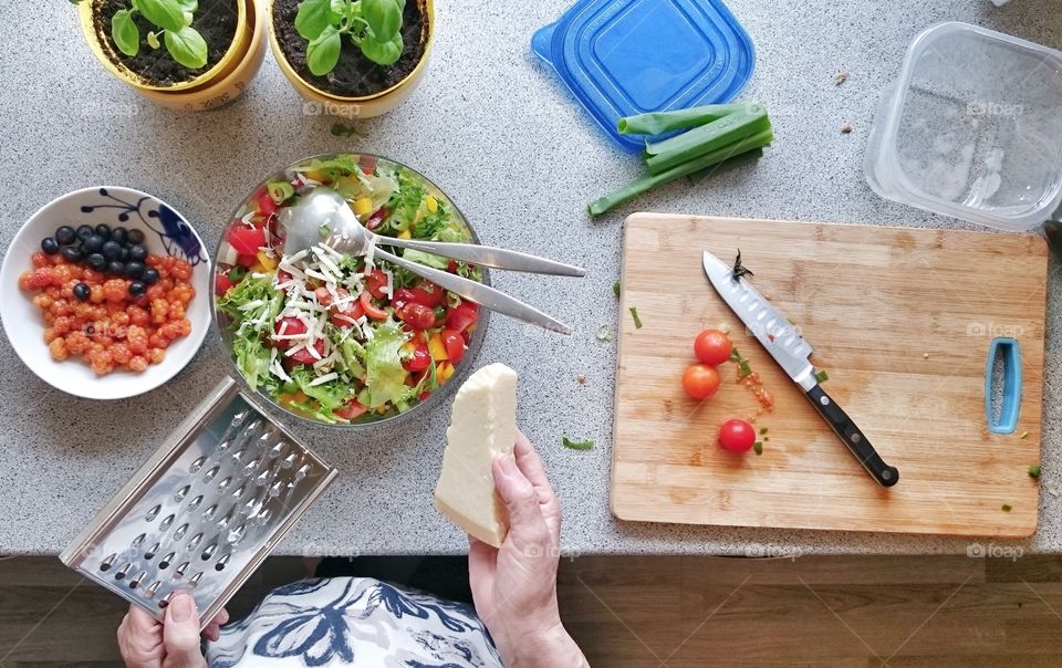 High angle view of woman grating cheese