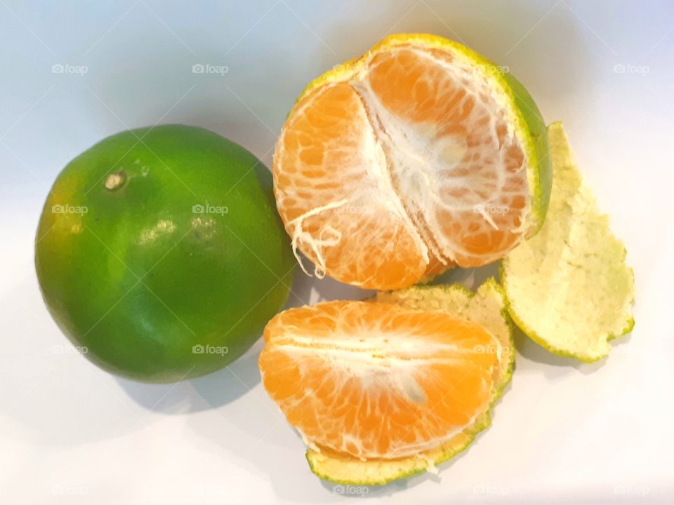 Fresh orange fruit peeled isolated on white background