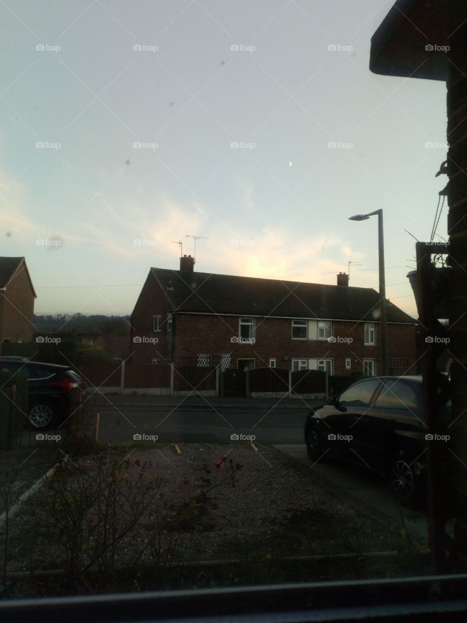 the start of a sunset with the moon out