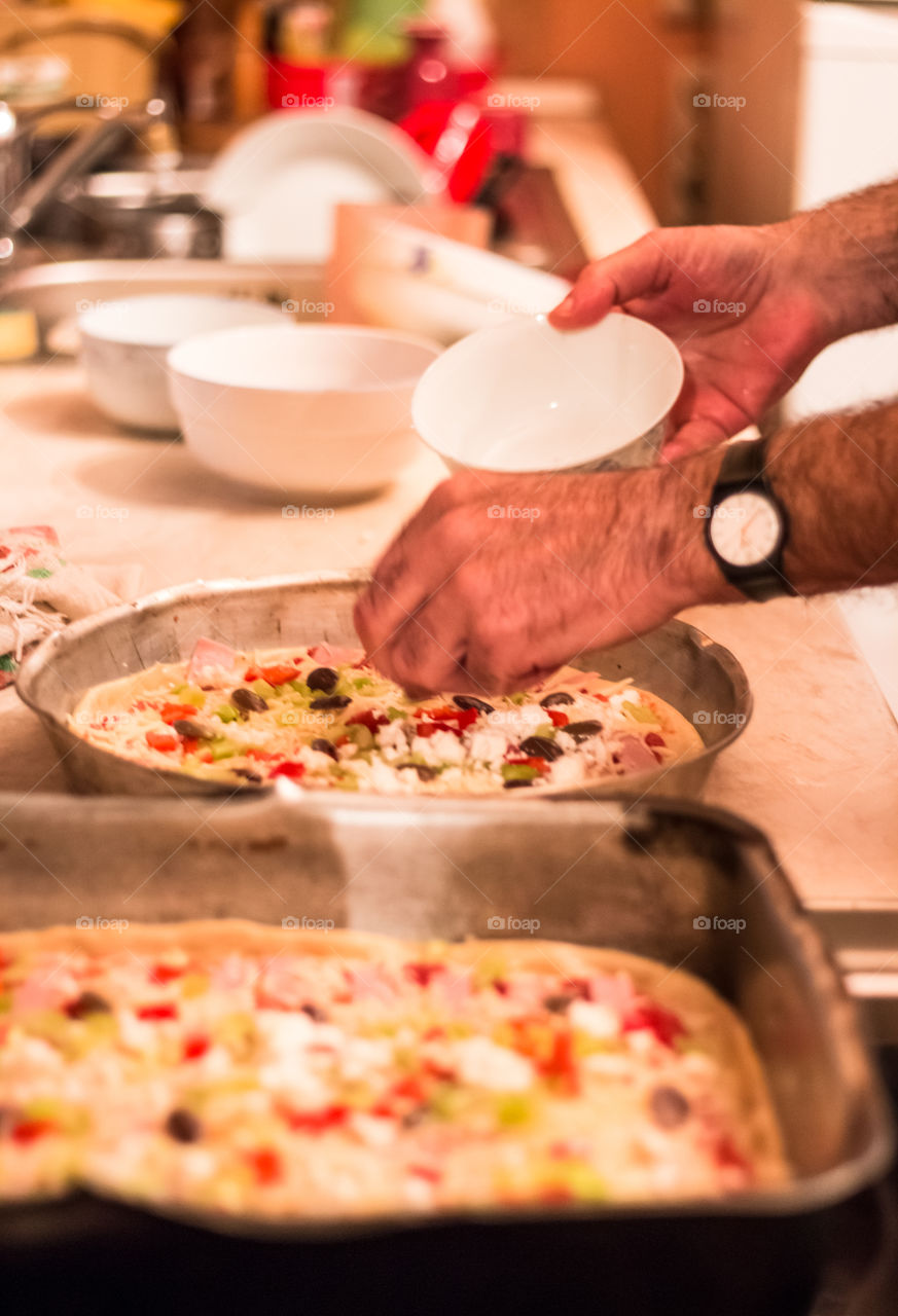 Men preparing pizza