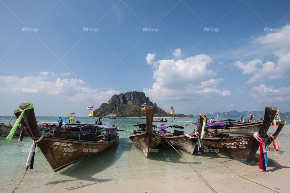 Longtail boat docking in the beach in Krabi Thailand 